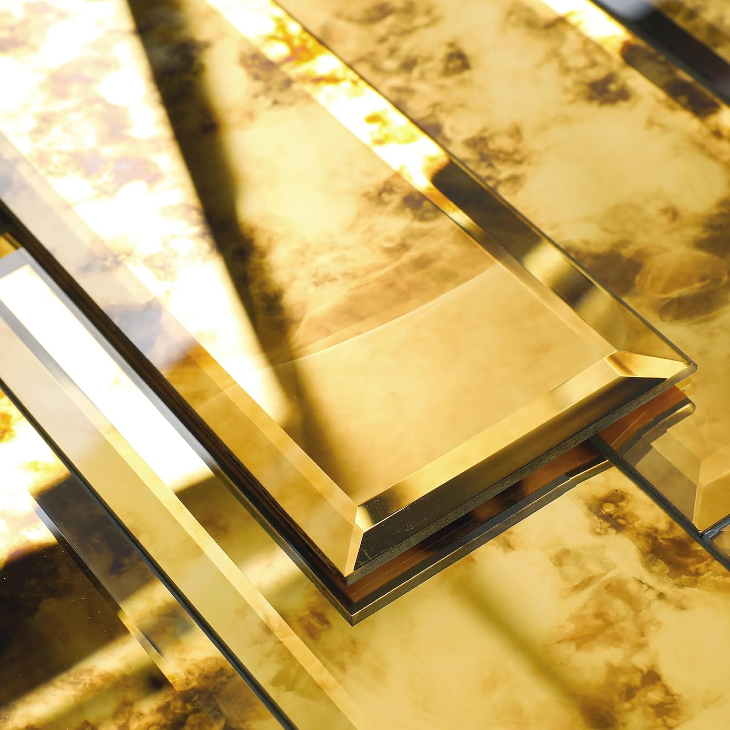 Lovdeco gold antique beveled mirror tile pieces at an angle, showing the warm gold reflective faces